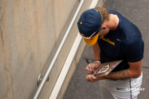 A West Virginia player signs an autograph during the CWS media day on June 11, 2026, in Omaha, Nebraska. Photo by Brandon Tiedemann.