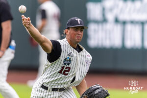 Troy Trojan 2026 pitcher Tate Farquhar (12) throws a pitch during the CWS media day on Thursday, June 11, 2026, in Omaha, Neb. Photo by John S. Peterson.