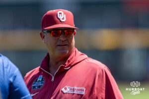 Oklahoma Sooner 2026 head coach Skip Johnson talks to a member of the media during the CWS media day on Thursday, June 11, 2026, in Omaha, Neb. Photo by John S. Peterson.