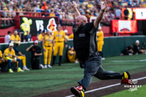 Savannah Banana dancing umpire jumps during a Banana ball game on June 13, 2026, in Omaha, Nebraska. Photo by Brandon Tiedemann.