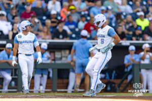 North Carolina Tar Heel Gavin Gallaher (5) is walked in for a run against the West Virginia Mountaineers in the first inning during the College World Series baseball tournament on Sunday, June 14, 2026, in Omaha, Neb. Photo by John S. Peterson.