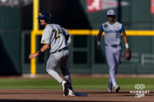 West Virginia Mountaineer Ben Lumsden (24) advances to second for a SAC flyball in the third against the North Carolina Tar Heels during the College World Series baseball tournament on Sunday, June 14, 2026, in Omaha, Neb. Photo by John S. Peterson.