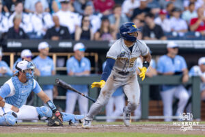 West Virginia Mountaineer utility Armani Guzman (5) singles driving in a run in the third a during the College World Series baseball tournament on Sunday, June 14, 2026, in Omaha, Neb. Photo by John S. Peterson.