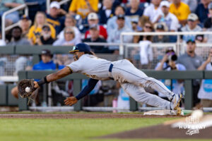 West Virginia Mountaineer utility Armani Guzman (5) makes the catch for the force out at first against the West Virginia Mountaineers in the sixth inning during the College World Series baseball tournament on Sunday, June 14, 2026, in Omaha, Neb. Photo by John S. Peterson.