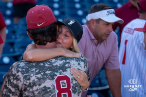 Alabamas Tyler Fay (8) hugs someone during a CWS game on June 15, 2026, in Omaha, Nebraska. Photo by Brandon Tiedemann.