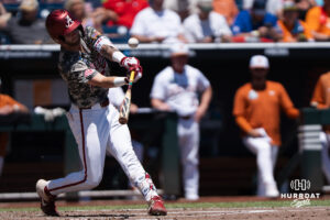 Alabamas Luke Vaughn (13) hits during a CWS game on June 15, 2026, in Omaha, Nebraska. Photo by Brandon Tiedemann.