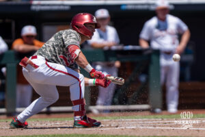 Alabamas Brennan Holt (4) bunts during a CWS game on June 15, 2026, in Omaha, Nebraska. Photo by Brandon Tiedemann.