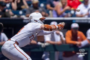 Texas Longhorn Ashton Larson (44) bunts during a CWS game on June 15, 2026, in Omaha, Nebraska. Photo by Brandon Tiedemann.