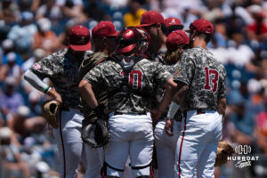 Alabama meets at the mound during a CWS game on June 15, 2026, in Omaha, Nebraska. Photo by Brandon Tiedemann.