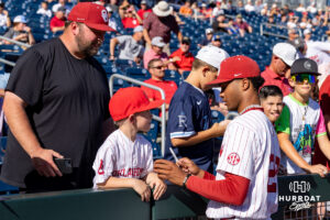 Oklahoma Sooner pitcher Lj Mercurius (22) signs an autograph before taking on the Georgia Bulldogs during the College World Series baseball tournament on Monday, June 15, 2026, in Omaha, Neb. Photo by John S. Peterson.