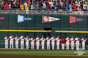 Oklahoma Sooners ptichers line up for the Nation Anthem beofre taking on the Georgia Bulldogs during the College World Series baseball tournament on Monday, June 15, 2026, in Omaha, Neb. Photo by John S. Peterson.