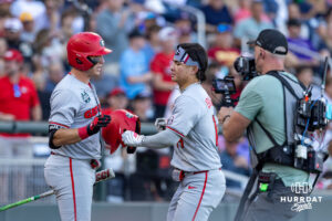 Georgia Bulldog Kenny Ishikawa (14) celebrates his home run with a teammate against the Oklahoma Sooners in the fourth inning during the College World Series baseball tournament on Monday, June 15, 2026, in Omaha, Neb. Photo by John S. Peterson.
