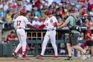 Oklahoma Sooner catcher Brendan Brock (10) celebrates his home run with teammate Dasan Harris against the Georgia Bulldogs in the fourth inning during the College World Series baseball tournament on Monday, June 15, 2026, in Omaha, Neb. Photo by John S. Peterson.
