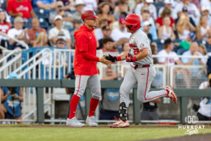 Georgia Bulldog catcher Brennan Hudson (28) gets five from the third base coach Brock Bennett while running bases for his home run in the fifth during the College World Series baseball tournament on Monday, June 15, 2026, in Omaha, Neb. Photo by John S. Peterson.