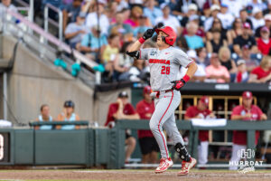 Georgia Bulldog catcher Brennan Hudson (28) gives a salute after crossing home plate after hitting a home run against the Oklahoma Sooners in the fifith inning during the College World Series baseball tournament on Monday, June 15, 2026, in Omaha, Neb. Photo by John S. Peterson.