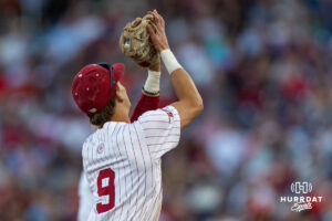 Oklahoma Sooner infielder Camden Johnson (9) makes a catch for an out against the Georgia Bulldogs in the eighth inning during the College World Series baseball tournament on Monday, June 15, 2026, in Omaha, Neb. Photo by John S. Peterson.