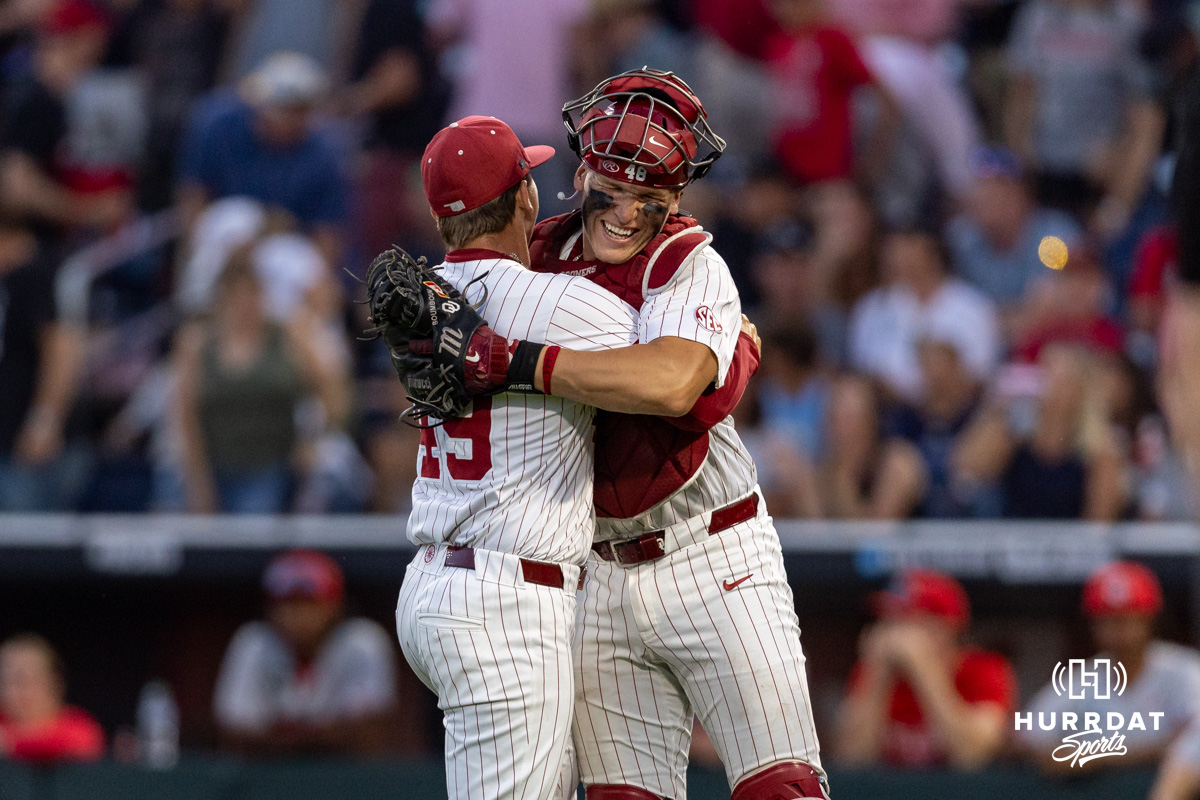 CWS Oklahoma v Alabama | June 15, 2026 | Hurrdat Sports Oklahoma Sooner pitcher Jackson Cleveland (49) and catcher Deiten Lachance (48) hug after the win over Georgia Bulldogs during the College World Series baseball tournament on Monday, June 15, 2026, in Omaha, Neb. Photo by John S. Peterson.