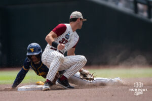 West Virginia Mountaineers Armani Guzman (5) steals second base during a CWS game on June 16, 2026, in Omaha, Nebraska. Photo by Brandon Tiedemann.