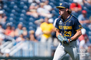 West Virginia Mountaineers Reese Bassinger (29) celebrates a strike out during a CWS game on June 16, 2026, in Omaha, Nebraska. Photo by Brandon Tiedemann.
