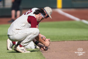Troy Trojans put dirt in cups after a CWS game on June 16, 2026, in Omaha, Nebraska. Photo by Brandon Tiedemann.