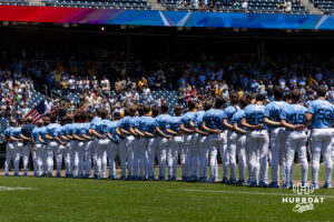 North Carolina Tar Heels line up for the National Anthem before taking on the West Virginia Mountaineers during the College World Series baseball tournament on Wednesday, June 17, 2026, in Omaha, Neb. Photo by John S. Peterson.