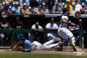 North Carolina Tar Heel 2026 infielder Jake Schaffner (2) slides at home for a run against the West Virginia Mountaineers in the first inning during the College World Series baseball tournament on Wednesday, June 17, 2026, in Omaha, Neb. Photo by John S. Peterson.