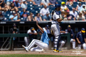 North Carolina Tar Heel 2026 utility Erik Paulsen (44) slides in for a run on a two-run triple in the third inning against the West Virginia Mountaineers during the College World Series baseball tournament on Wednesday, June 17, 2026, in Omaha, Neb. Photo by John S. Peterson.