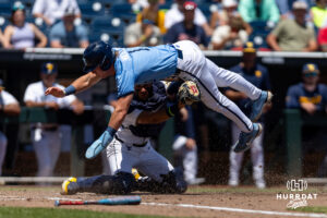 North Carolina Tar HeelCooper Nicholson (1) out at home trying to dive over the tag by West Virginia Mountaineer catcher Matthew Graveline (0) during the College World Series baseball tournament on Wednesday, June 17, 2026, in Omaha, Neb. Photo by John S. Peterson.