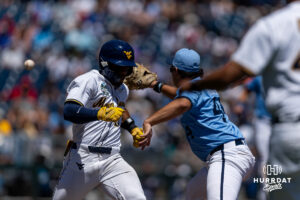 West Virginia Mountaineer utility Armani Guzman (5) beats the ball to first against North Carolina Tar Heel utility Erik Paulsen (44) in the third inning during the College World Series baseball tournament on Wednesday, June 17, 2026, in Omaha, Neb. Photo by John S. Peterson.