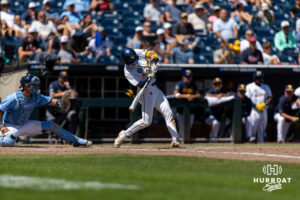 West Virginia Mountaineer Gavin Kelly (2) hits a one-run triple in the seveth against the North Carolina Tar Heels during the College World Series baseball tournament on Wednesday, June 17, 2026, in Omaha, Neb. Photo by John S. Peterson.
