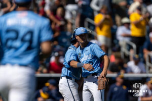 North Carolina Tar Heel pitcher Caden Glauber (27) hugs the catcher Colin Hynek (23) celebrating the win over the West Virginia Mountaineers sendin the to the finals during the College World Series baseball tournament on Wednesday, June 17, 2026, in Omaha, Neb. Photo by John S. Peterson.
