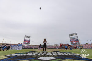 An F18 does a flyover while the National Anthem is being performed before the North Carolina Tar Heels take on the Oklahoma Sooners during the Finals of the College World Series baseball tournament on Saturday, June 20, 2026, in Omaha, Neb. Photo by John S. Peterson.