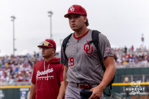 Oklahoma Sooner pitcher Cord Rager (99) walks to the dugout after warming up against the North Carolina Tar Heels during the Finals of the College World Series baseball tournament on Saturday, June 20, 2026, in Omaha, Neb. Photo by John S. Peterson.