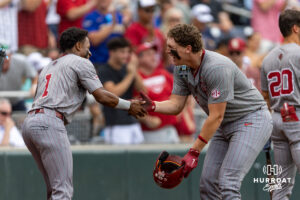Oklahoma Sooner catcher Deiten Lachance (48) celebrates his home run with Jason Walk against the North Carolina Tar Heels in the first inning during the Finals of the College World Series baseball tournament on Saturday, June 20, 2026, in Omaha, Neb. Photo by John S. Peterson.