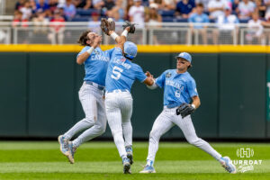North Carolina Tar Heel Gavin Gallaher (5) and Jake Schaffner (2) collide, dropping the ball with Owen Hull watching against the Oklahoma Sooners during the Finals of the College World Series baseball tournament on Saturday, June 20, 2026, in Omaha, Neb. Photo by John S. Peterson.