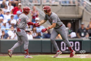 Oklahoma Sooner Deiten Lachance (48) recieves five from Jaxon Willits after hitting a home run against the North Carolina Tar Heels during the Finals of the College World Series baseball tournament on Saturday, June 20, 2026, in Omaha, Neb. Photo by John S. Peterson.