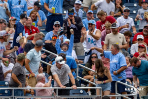 A young CWS fan makes a catch of a foul ball in the game between North Carolina Tar Heels and Oklahoma Sooners during the Finals of the College World Series baseball tournament on Saturday, June 20, 2026, in Omaha, Neb. Photo by John S. Peterson.