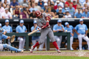 Oklahoma Sooner infielder Kyle Branch (6) hits a two-run single, driving in Dasan Harris, and Brendan Brock against the North Carolina Tar Heels in the fourth inning during the Finals of the College World Series baseball tournament on Saturday, June 20, 2026, in Omaha, Neb. Photo by John S. Peterson.