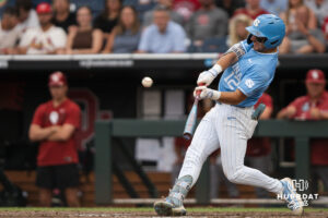 North Carolina Tar Heels Tyler Howe (12) hits during the fifth inning of a CWS game on June 20, 2026, in Omaha, Nebraska. Photo by Brandon Tiedemann.