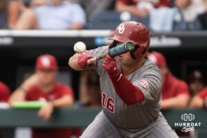 Oklahoma Sooners Dayton Tockey (16) bunts during the eight inning of a CWS game on June 20, 2026, in Omaha, Nebraska. Photo by Brandon Tiedemann.