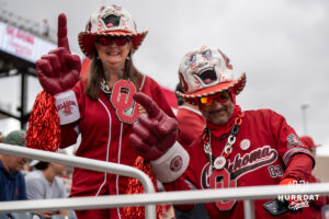 Oklahoma Sooners fans smile before a CWS game on June 21, 2026, in Omaha, Nebraska. Photo by Brandon Tiedemann.