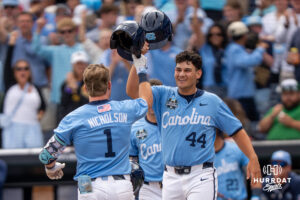 North Carolina Tar Heels Cooper Nicholson (1) and Erik Paulsen (44) high five during the seventh inning of a CWS game on June 21, 2026, in Omaha, Nebraska. Photo by Brandon Tiedemann.