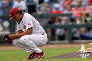 Oklahoma Sooners Trent Collier (39) kneels down and prays during the ninth inning of a CWS game on June 21, 2026, in Omaha, Nebraska. Photo by Brandon Tiedemann.