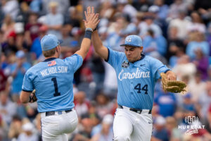 North Carolina Tar Heels Erik Paulsen (44) and Cooper Nicholson (1) high five after a CWS game on June 21, 2026, in Omaha, Nebraska. Photo by Brandon Tiedemann.