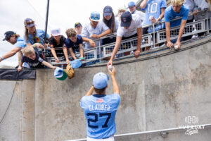 North Carolina Tar Heel pitcher Caden Glauber (27) signs autographs after the win against the Oklahoma Sooners during game two of the Finals of the College World Series baseball tournament on Sunday, June 21, 2026, in Omaha, Neb. Photo by John S. Peterson.
