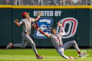 Oklahoma Sooners Jason Walk (1) and Dasan Harris (17) almost collide during the first inning of a CWS game on June 22, 2026, in Omaha, Nebraska. Photo by Brandon Tiedemann.