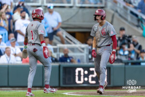 Oklahoma Sooner Camden Johnson (9) and Jason Walk (1) celebrate their runs in the fourth inning against the North Carolina Tar Heels during game three of the Finals of the College World Series baseball tournament on Monday, June 22, 2026, in Omaha, Neb. Photo by John S. Peterson.