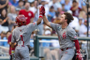 Oklahoma Sooner infielder Dayton Tockey (16) gets a high five from Jason Walk (1) after hitting a home run against the North Carolina Tar Heels in the fifith inning during game three of the Finals of the College World Series baseball tournament on Monday, June 22, 2026, in Omaha, Neb. Photo by John S. Peterson.