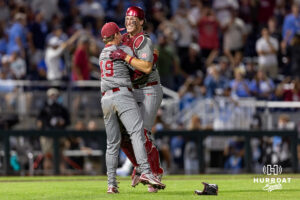 Oklahoma Sooner pitcher Jackson Cleveland (49) and catcher Deiten Lachance (48) hug, celebrating winning the National Championship against the North Carolina Tar Heels during game three of the Finals of the College World Series baseball tournament on Monday, June 22, 2026, in Omaha, Neb. Photo by John S. Peterson.