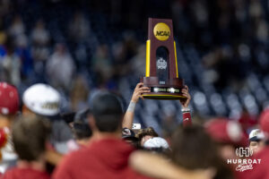 Oklahoma Sooner player lifts the National Championship trophy up after the win over the North Carolina Tar Heels during game three of the Finals of the College World Series baseball tournament on Monday, June 22, 2026, in Omaha, Neb. Photo by John S. Peterson.